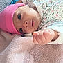 Bayan participe au concours pour gagner de l'argent avec cette photo : baby, infant, pink_hat, floral_onesie, towel, close_up, hand, face, skin, cute, newborn, soft_texture, lying_down, indoors, child, expression, small_hand, apparel, person, portrait