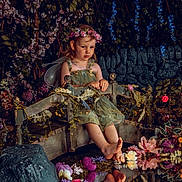 Erica is registered to the contest to win money with this photo: child, girl, flower_crown, fairy_wings, green_dress, bridge, flowers, reflection, water, nature, foliage, decorative, portrait, sitting, fantasy, garden, cute, whimsical, peaceful, young