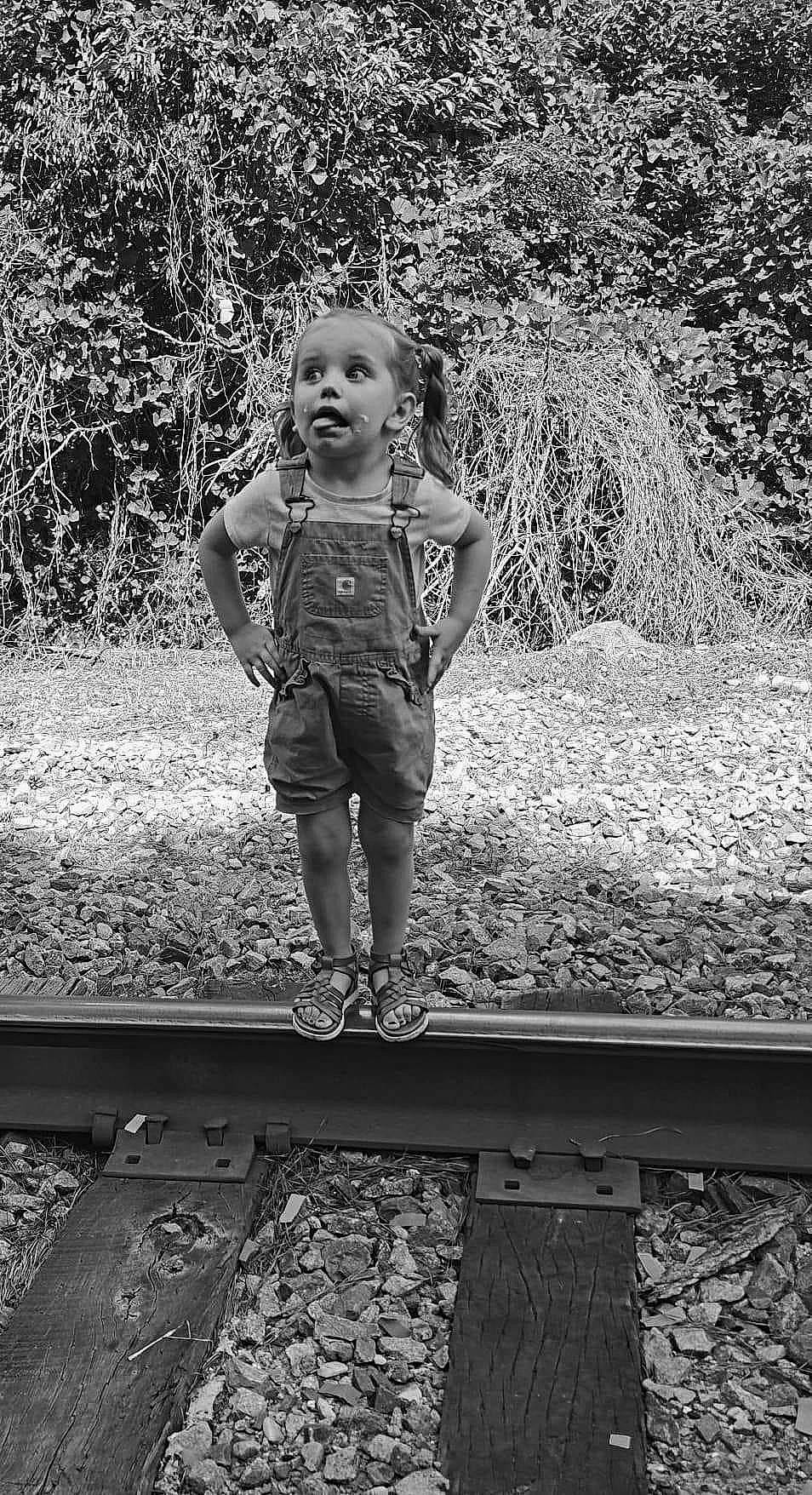 Elizabeth joined the competition — help win amazing prizes! black, black_and_white, flash_photography, gesture, grass, grey, happy, human_body, leaf, nature, people_in_nature, person, photograph, plant, standing, style, toddler, track, tree, white