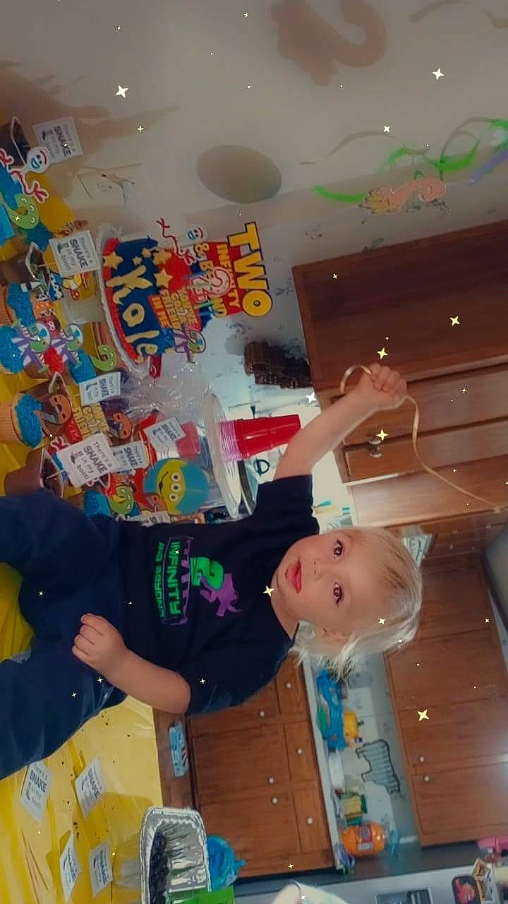 Kolton is registered to the contest to win money with this photo: art, ceiling, child, event, fun, hat, leisure, paint, party_supply, person, plastic, play, recreation, room, space, t_shirt, toddler, visual_arts, world