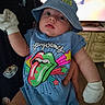 apparel, baby, blue_hat, child, closeup, colorful_clothing, curious_expression, cute, hand, headwear, holding, indoor, infant, mittens, onesie, person, portrait, rolling_stones, soft_lighting, wide_eyes
