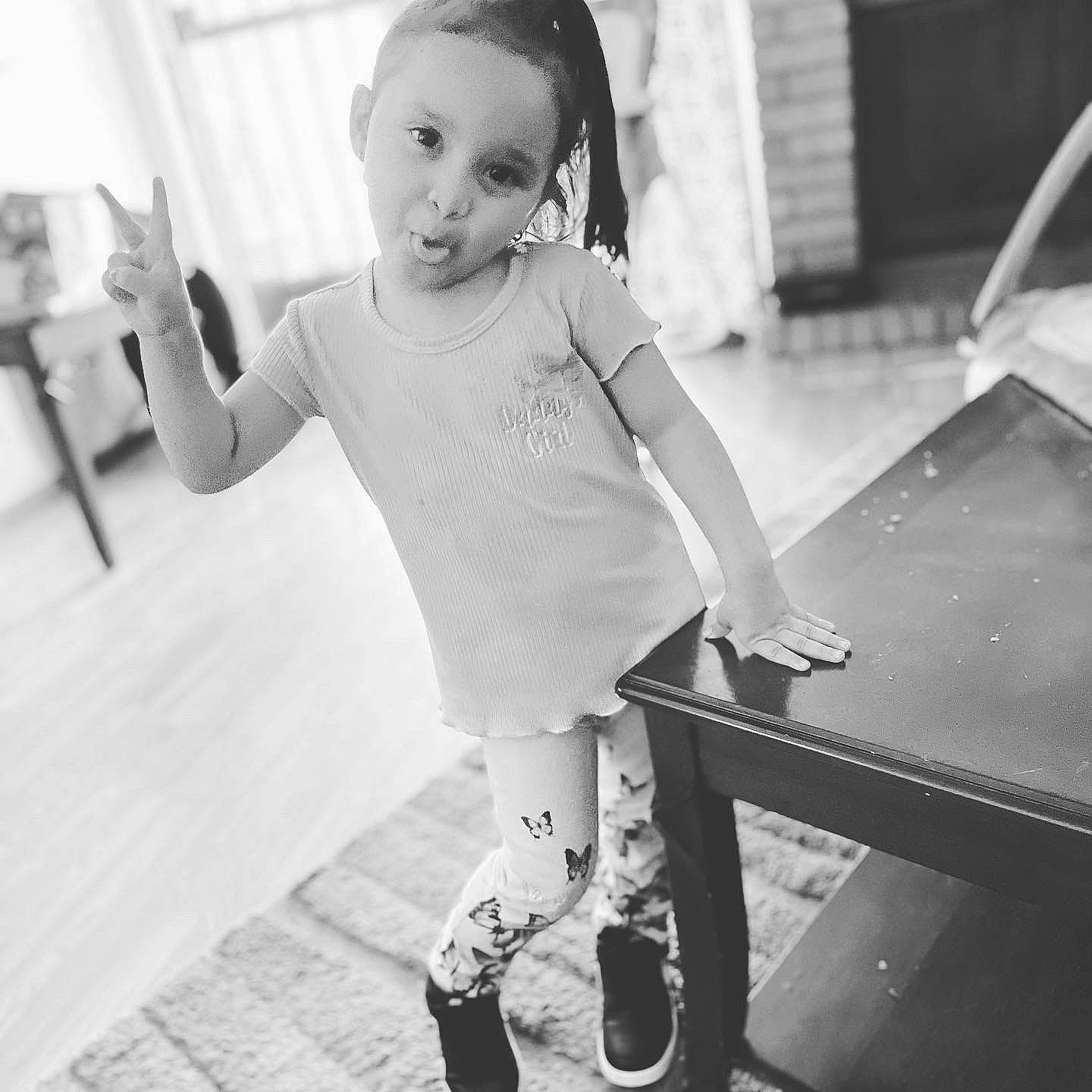 Meilani is registered to the contest to win money with this photo: baby, black, black_and_white, child, flash_photography, fun, gesture, happy, human_body, human_leg, leg, monochrome, monochrome_photography, person, sleeve, smile, snapshot, standing, style, toddler