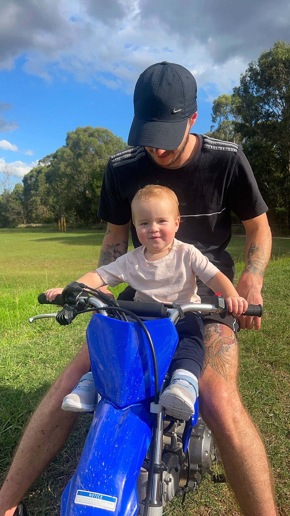 Lylah is registered to the contest to win money with this photo: baseball_cap, bicycle_wheel, cloud, electric_blue, grass, grassland, happy, joy, lap, lawn, leisure, meadow, people_in_nature, person, plant, recreation, shorts, sky, t_shirt, tire