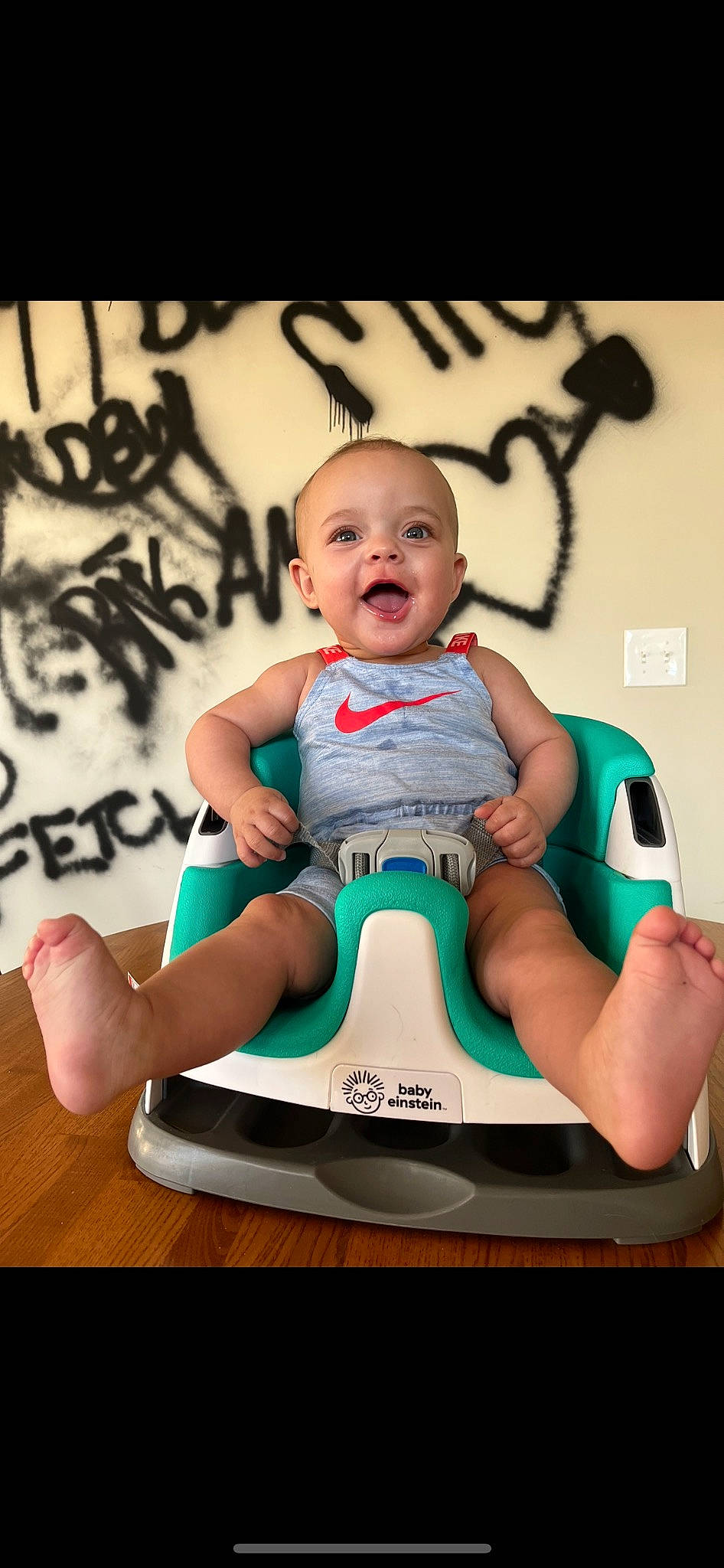 Cora joined the competition — help win amazing prizes! baby, baby_toddler_clothing, cheek, child, flash_photography, font, fun, happy, human_leg, jewellery, knee, logo, person, room, sitting, smile, sportswear, t_shirt, thigh, toddler