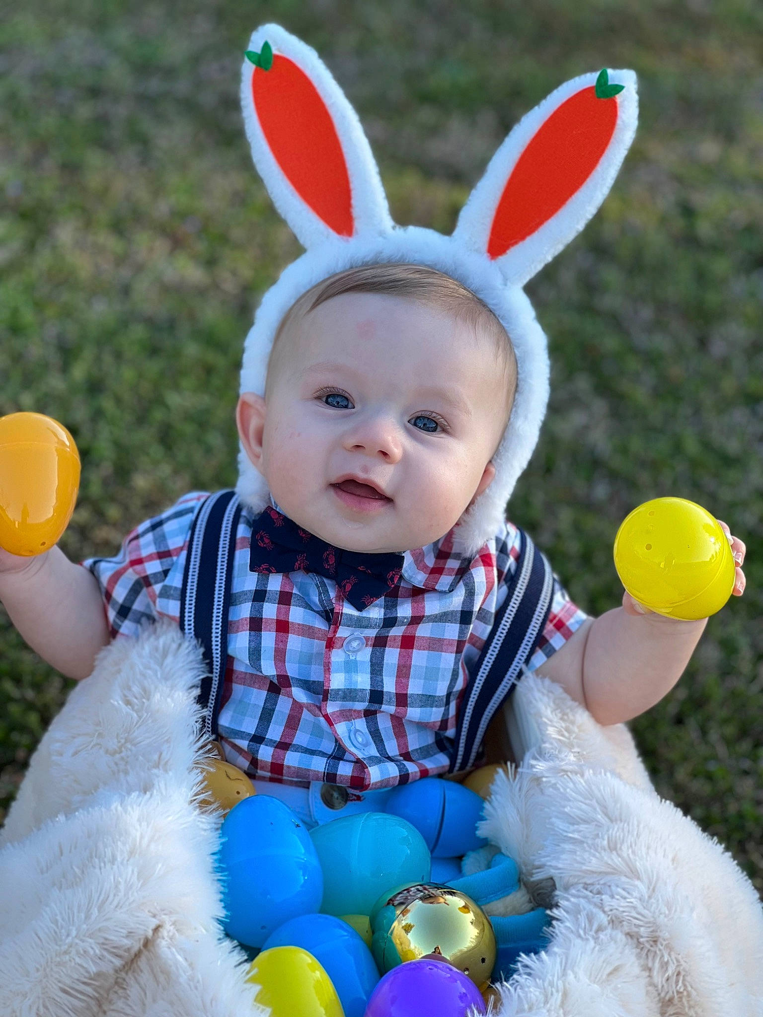Harrison is registered to the contest to win money with this photo: baby_toddler_clothing, child, facial_expression, fun, grass, green, happy, head, light, party_supply, person, photograph, pink, product, smile, summer, textile, toddler, toy, white