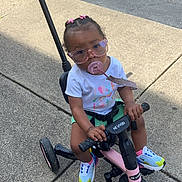 Adore is registered to the contest to win money with this photo: car, child, city, clothing, face, female, footwear, head, machine, person, photography, portrait, road, shoe, spoke, street, transportation, urban, vehicle, wheel