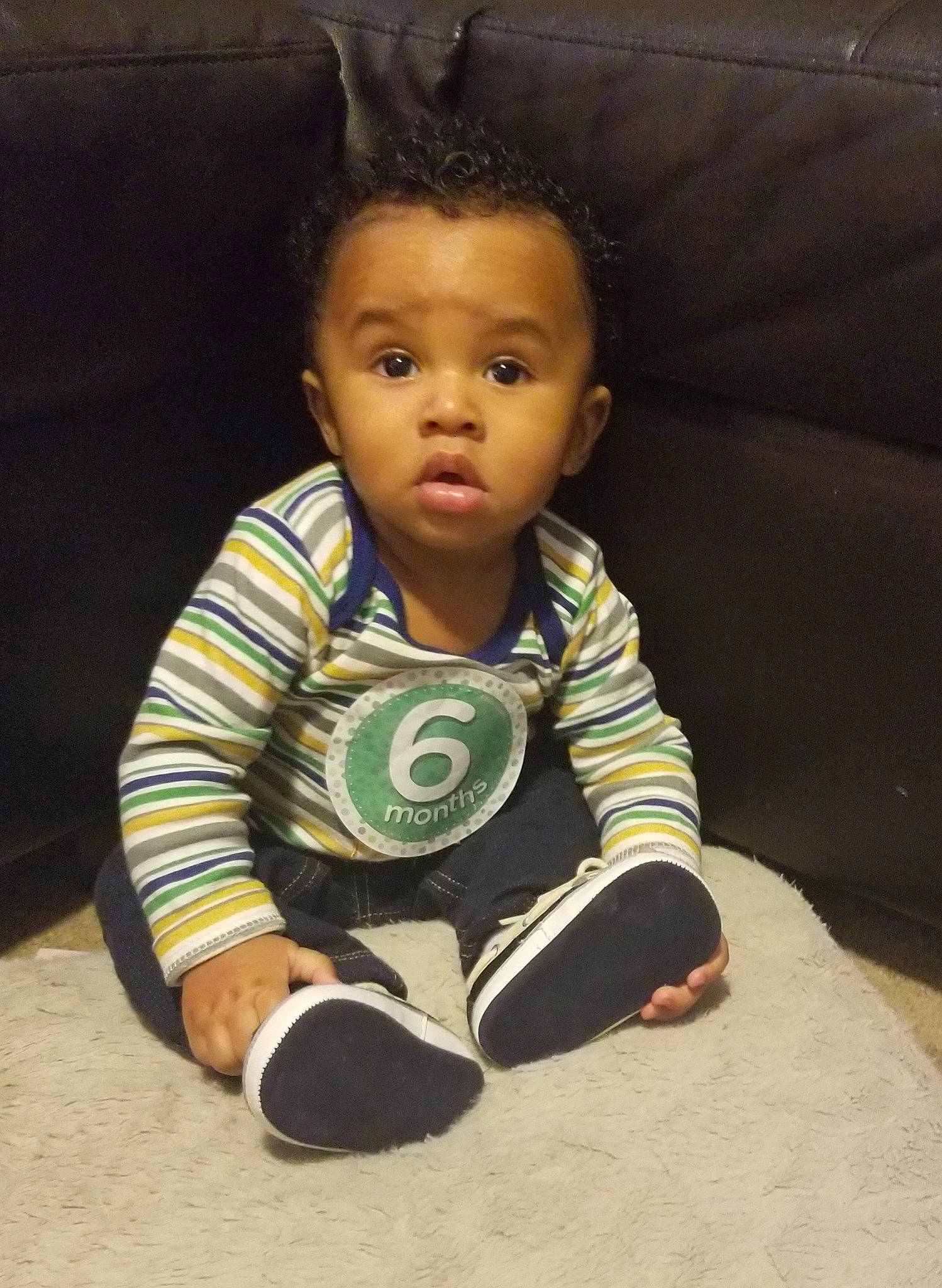 Tristan is registered to the contest to win money with this photo: baby, cheek, child, face, forehead, head, person, sitting, skin, surprise, toddler