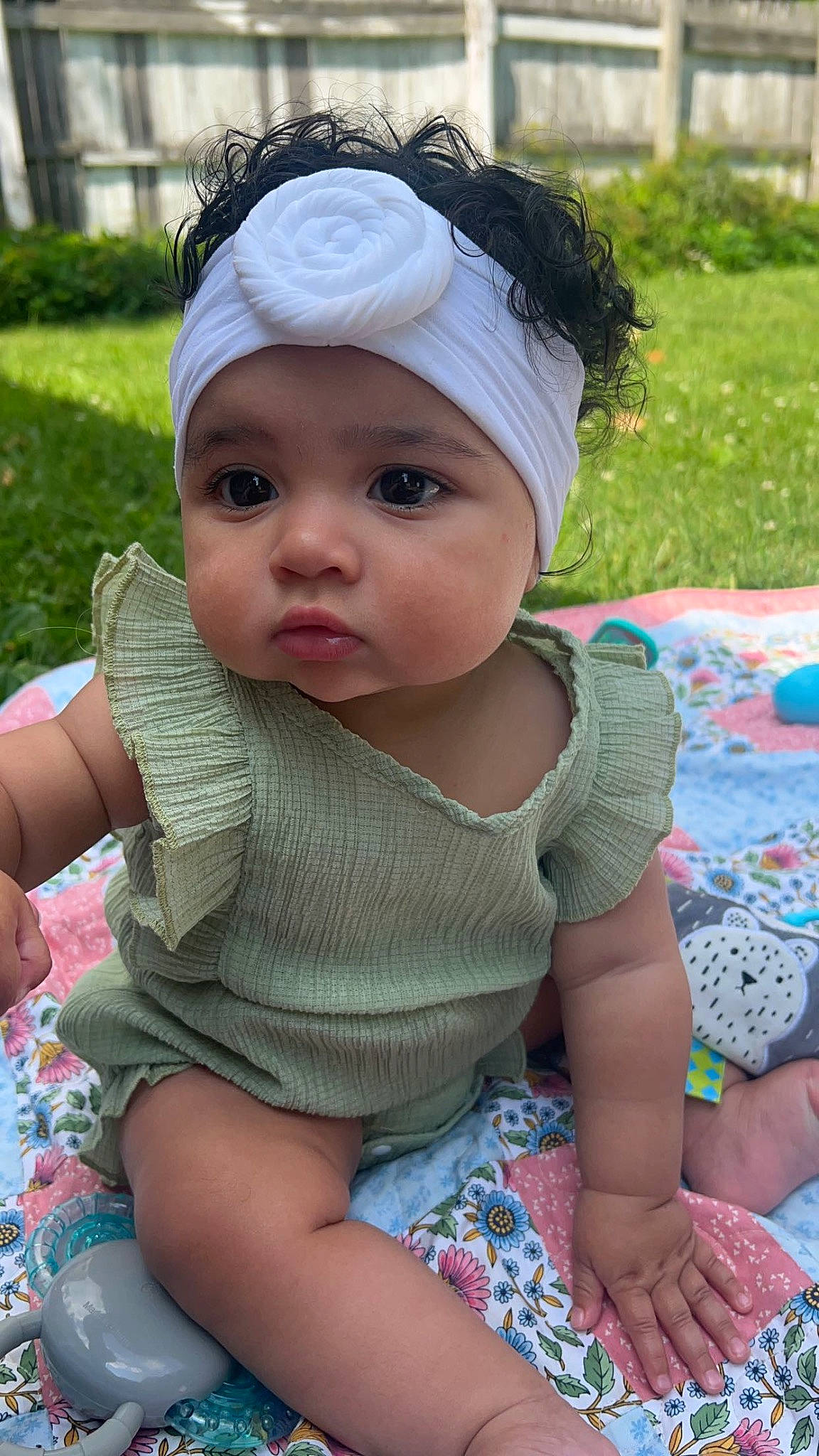 Isla is registered to the contest to win money with this photo: baby, baby_toddler_clothing, blue, cap, cheek, child, fun, grass, green, hat, head, headgear, headwear, lip, person, pink, plant, product, recreation, skin