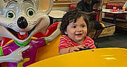Dariel Kaled is registered to the contest to win money with this photo: toddler, child, smile, arcade, indoor, ride, toy, colorful, amusement, family, entertainment, person, statue, happy, fun, game, restaurant, table, people, clothing