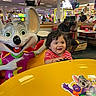toddler, child, smile, arcade, indoor, ride, toy, colorful, amusement, family, entertainment, person, statue, happy, fun, game, restaurant, table, people, clothing