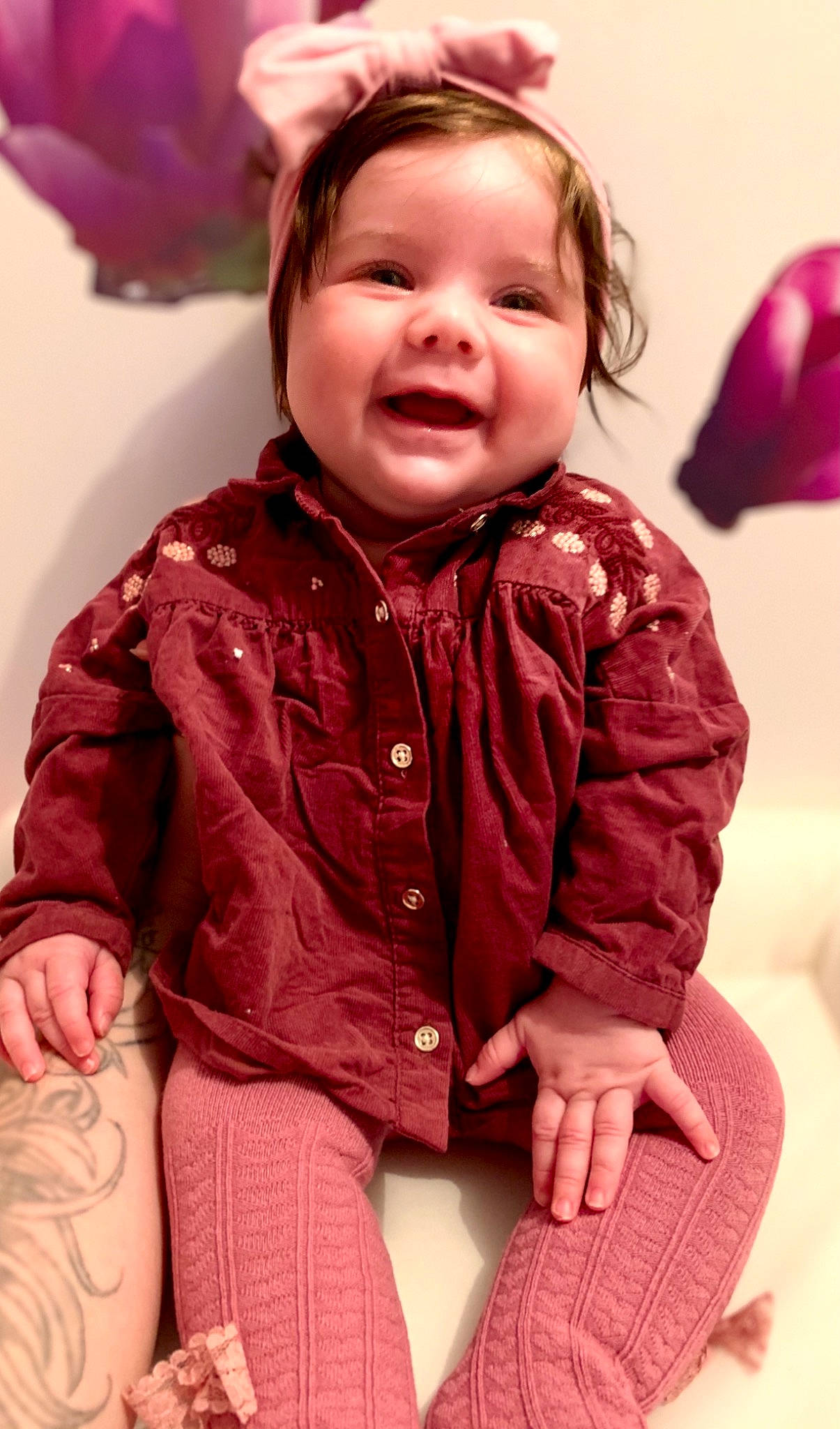 Rose participe au concours pour gagner de l'argent avec cette photo : baby, baby_toddler_clothing, cheek, child, facial_expression, happy, iris, lip, magenta, nose, organ, party_supply, person, pink, purple, sitting, skin, sleeve, toddler, toy