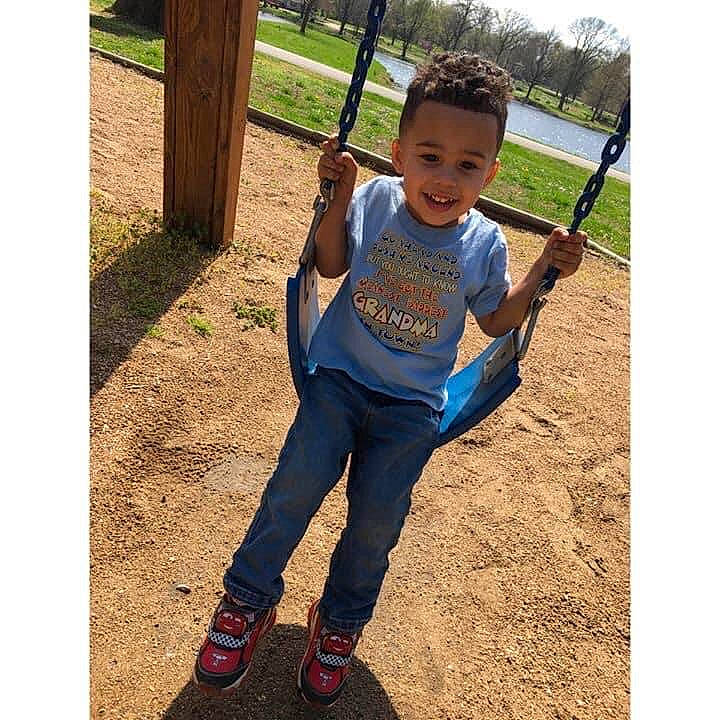 Braydon joined the competition — help win amazing prizes! baby, child, city, cool, denim, footwear, happy, human_settlement, jeans, joy, outdoor_play_equipment, person, play, playground, public_space, shoe, smile, swing, t_shirt, toddler