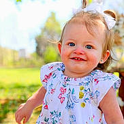 Willow joined the competition — help win amazing prizes! toddler, child, smiling, blue_eyes, white_bow, floral_dress, outdoor, sunny, greenery, nature, portrait, happy, cute, person, young_child, grass, daylight, face, baby, playful