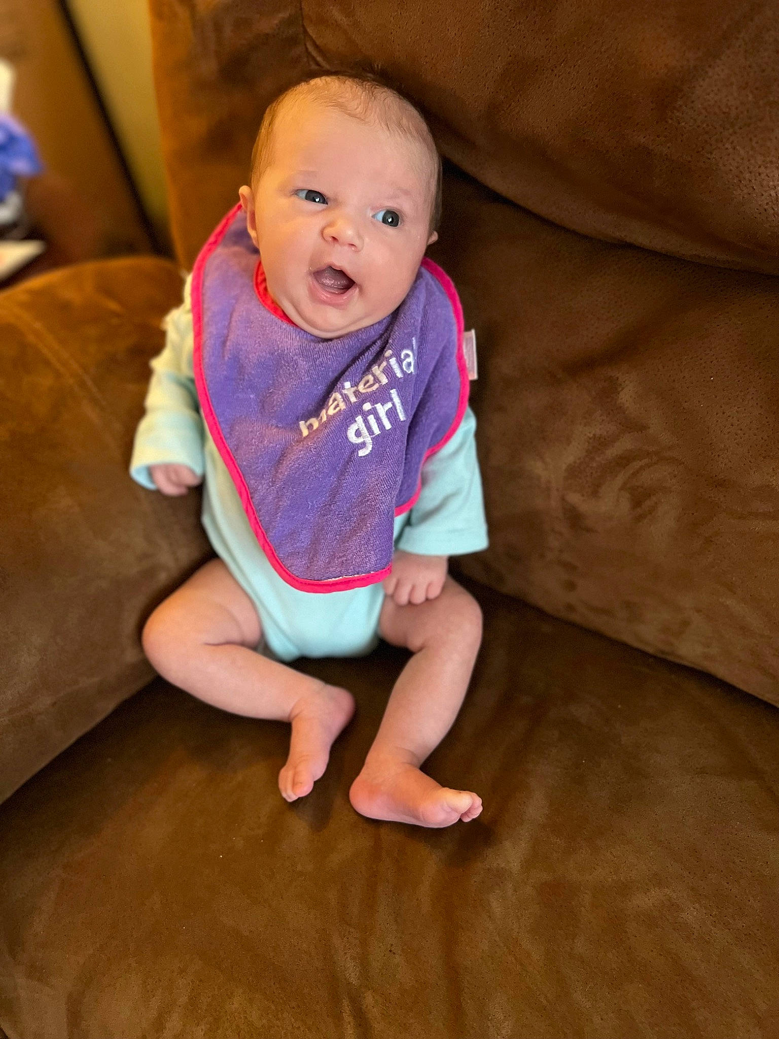 Giavanna is registered to the contest to win money with this photo: baby, baby_toddler_clothing, cheek, comfort, couch, floor, flooring, foot, hardwood, head, human_leg, knee, lap, leg, person, sleeve, smile, sock, thigh, toddler