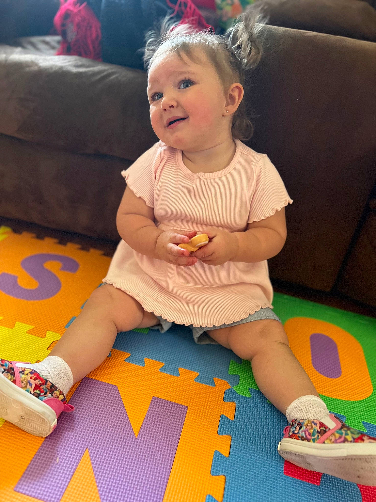 Sebastiana is registered to the contest to win money with this photo: baby, baby_toddler_clothing, child, comfort, couch, face, fun, happy, human_leg, lap, leg, person, pink, shoe, sitting, skin, smile, snapshot, sock, thigh