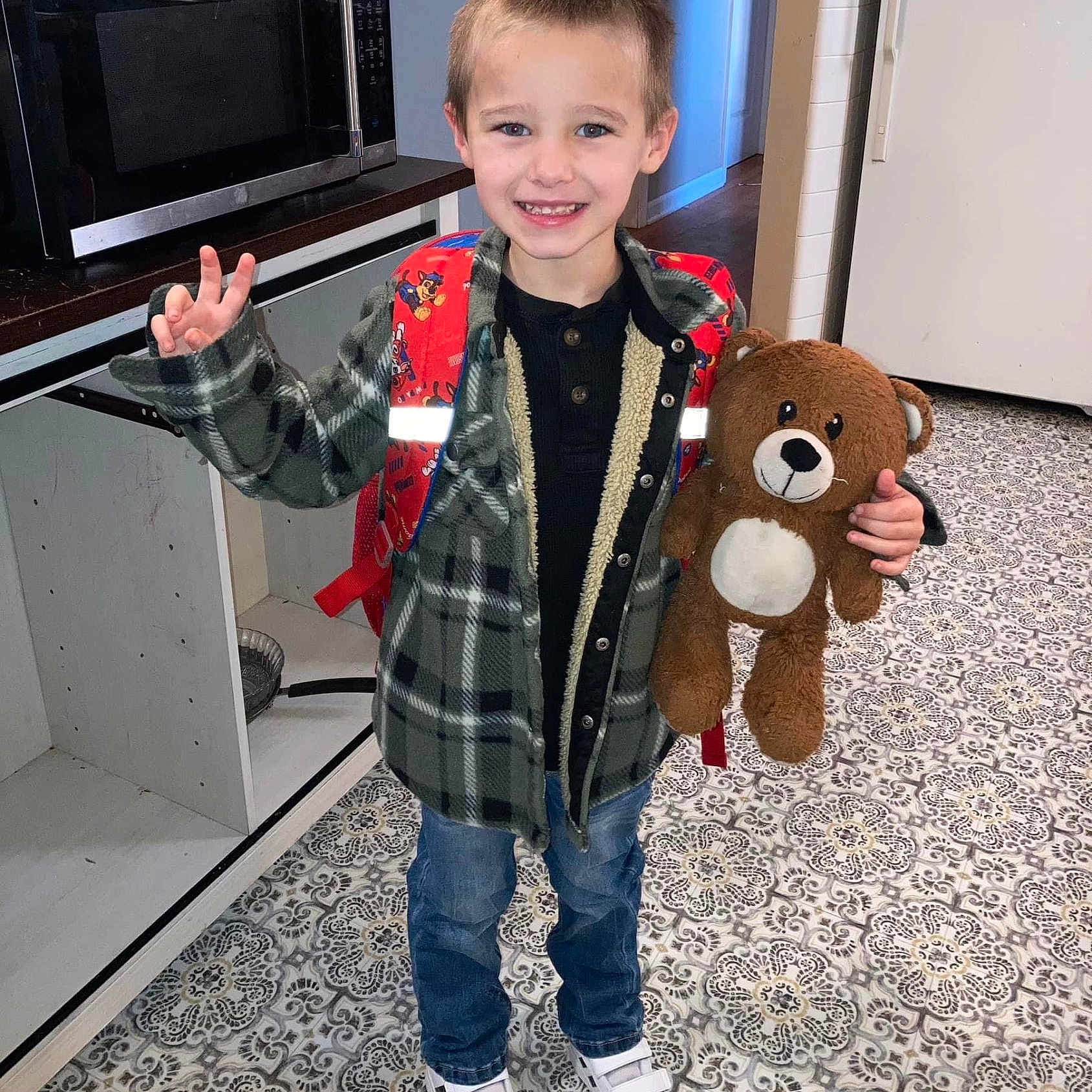 Landon is registered to the contest to win money with this photo: appliance, boy, child, clothing, device, electricaldevice, face, hair, head, jeans, male, microwave, oven, pants, person, photography, portrait, sleeve, standing, toy