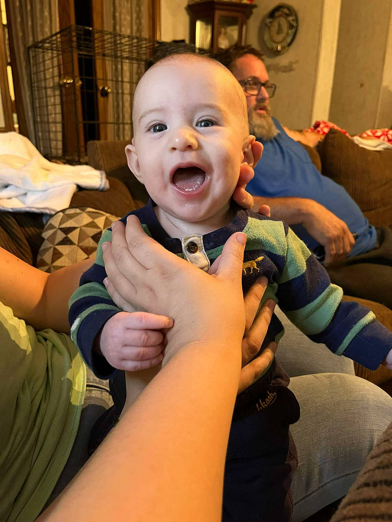 Reid is registered to the contest to win money with this photo: baby, baby_toddler_clothing, cheek, child, comfort, elbow, finger, fun, gesture, happy, human_leg, iris, mouth, nail, person, sitting, smile, thigh, thumb, toddler