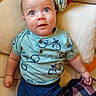 Baruk joined the competition — help win amazing prizes! baby, blanket, blue_eyes, child, close_up, clothing, couch, cozy, cushion, face, home, indoors, infant, pants, photography, portrait, shirt, sitting, smiling, wide_eyed