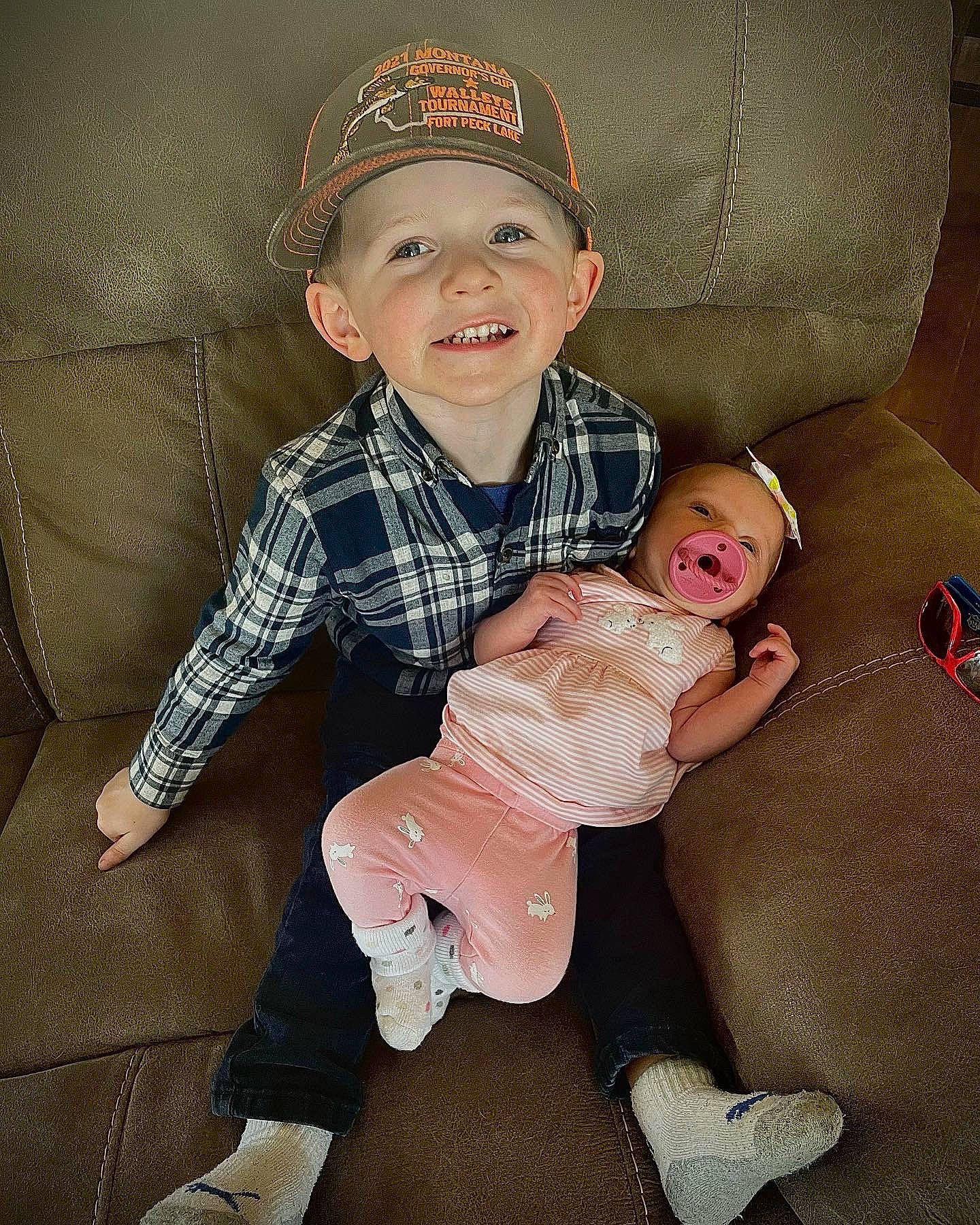 Brantley joined the competition — help win amazing prizes! baby, baby_toddler_clothing, cap, comfort, face, facial_expression, flash_photography, headwear, joy, knee, lap, leg, person, shoe, skin, sleeve, smile, sneakers, sock, textile