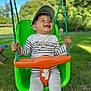 Raphaël a rejoint le concours — aidez-le/la à gagner de superbes lots ! child, toddler, swing, green_swing, orange_swing, cap, smiling, outdoor, grass, trees, playground, happy, baby_clothes, nature, daylight, park, toy, rope, seat, person