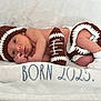 Noah is registered to the contest to win money with this photo: newborn, baby, infant, crochet, football, hat, shorts, sock, blanket, white, brown, laying_down, portrait, cute, soft, cozy, newborn_photo, child, baby_clothing, sleeping_area