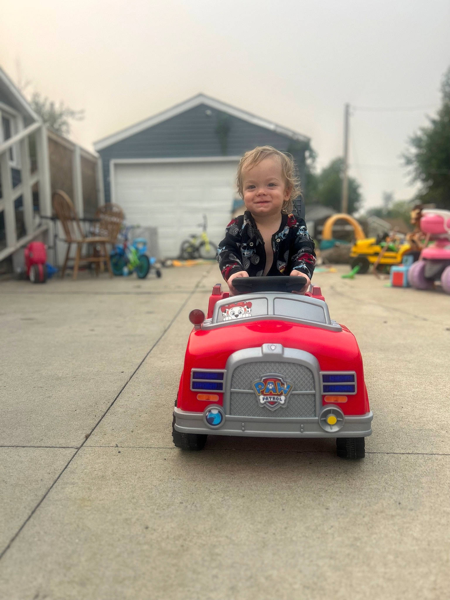 Sebastian is registered to the contest to win money with this photo: asphalt, automotive_design, automotive_exterior, automotive_tire, building, car, classic_car, jacket, joy, motor_vehicle, motorsport, person, race_track, racing, riding_toy, sky, smile, tire, tree, vehicle