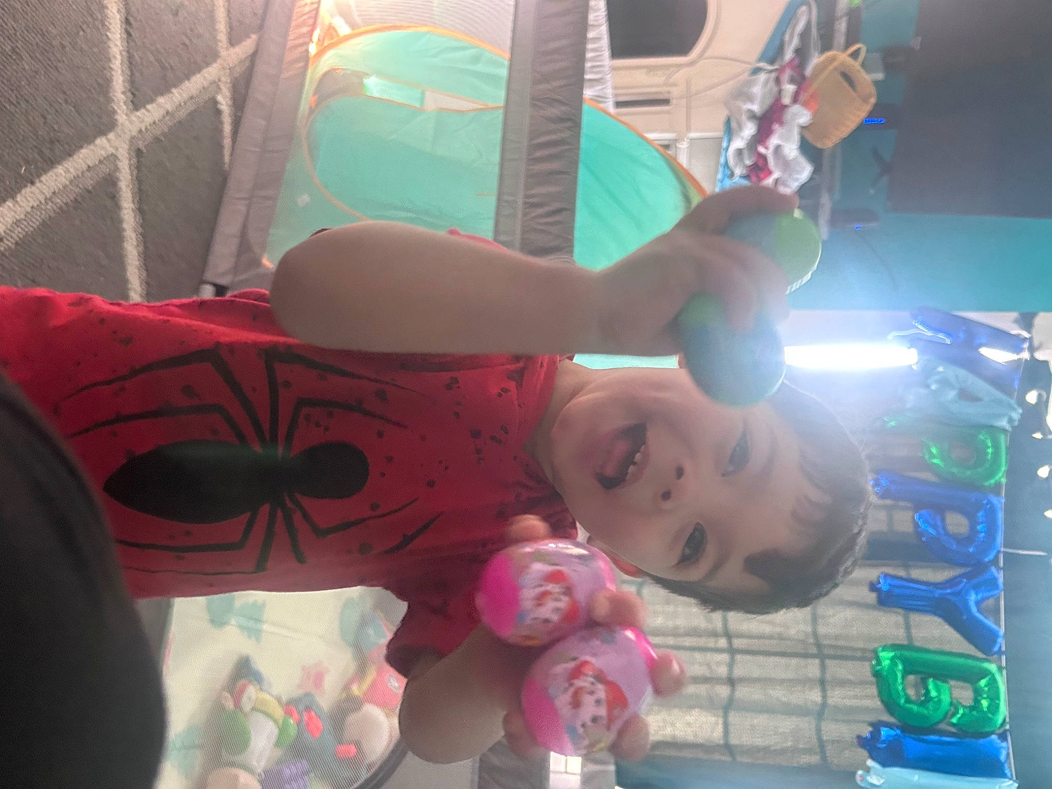 Dominic is registered to the contest to win money with this photo: child, cool, fun, happy, human_leg, leisure, magenta, mouth, party, party_supply, pattern, person, pink, play, recreation, room, smile, t_shirt, thigh, toddler