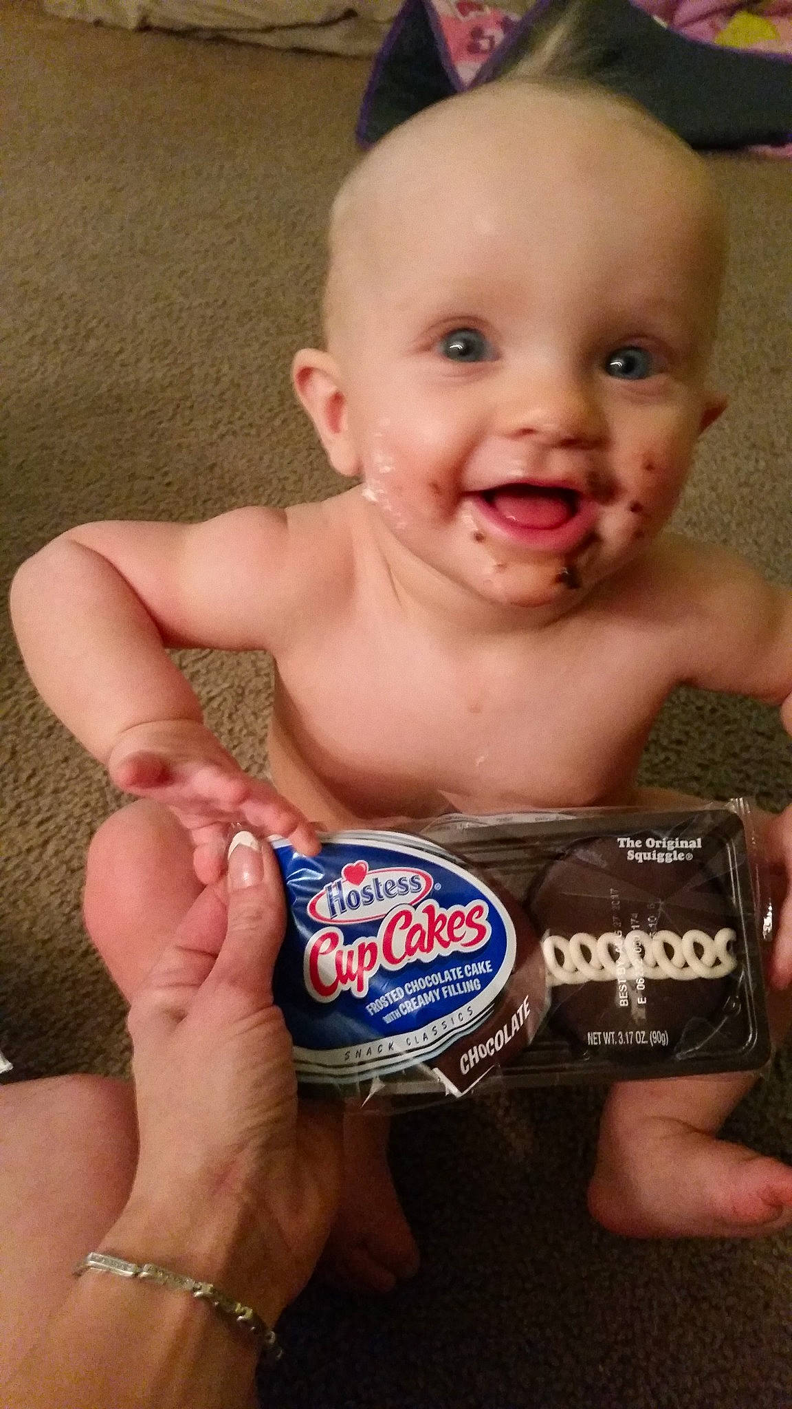 Charlee is registered to the contest to win money with this photo: baby, chest, child, chocolate, drink, electric_blue, finger, food, gesture, hand, happy, junk_food, logo, nail, person, smile, snack, sweetness, thumb, toddler