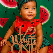 Khiari joined the competition — help win amazing prizes! baby, child, watermelon, birthday, sign, red_clothing, headband, green_background, cute, sitting, smiling, portrait, celebration, fruit, skin, hand, foot, decor, photography, happy