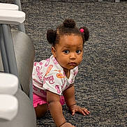 Faith joined the competition — help win amazing prizes! toddler, child, baby, crawling, portrait, face, pigtails, hair_bows, curious, serious_expression, indoors, carpet, floor, high_chair, furniture, pink_clothing, patterned_shirt, sitting, hands, daycare
