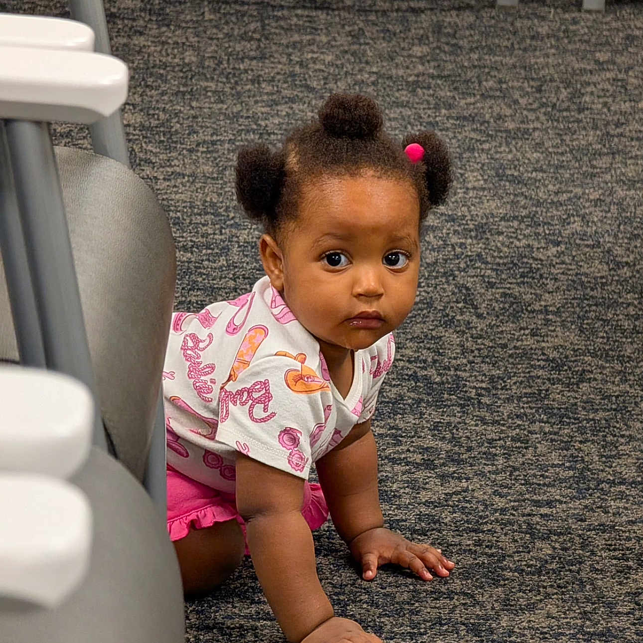 Faith joined the competition — help win amazing prizes! toddler, child, baby, crawling, portrait, face, pigtails, hair_bows, curious, serious_expression, indoors, carpet, floor, high_chair, furniture, pink_clothing, patterned_shirt, sitting, hands, daycare