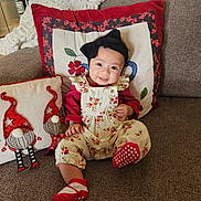 Cosette joined the competition — help win amazing prizes! baby, child, smiling, sitting, couch, pillow, headband, floral, clothing, indoors, home, cozy, cute, red, white, decor, happy, infant, portrait, comfortable