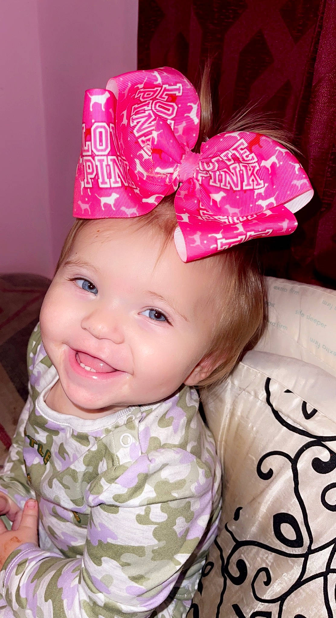 Natalie is registered to the contest to win money with this photo: baby_toddler_clothing, cap, chin, cool, costume_hat, hairstyle, happy, hat, head, headgear, headwear, joy, lip, magenta, pattern, person, pink, product, skin, sleeve