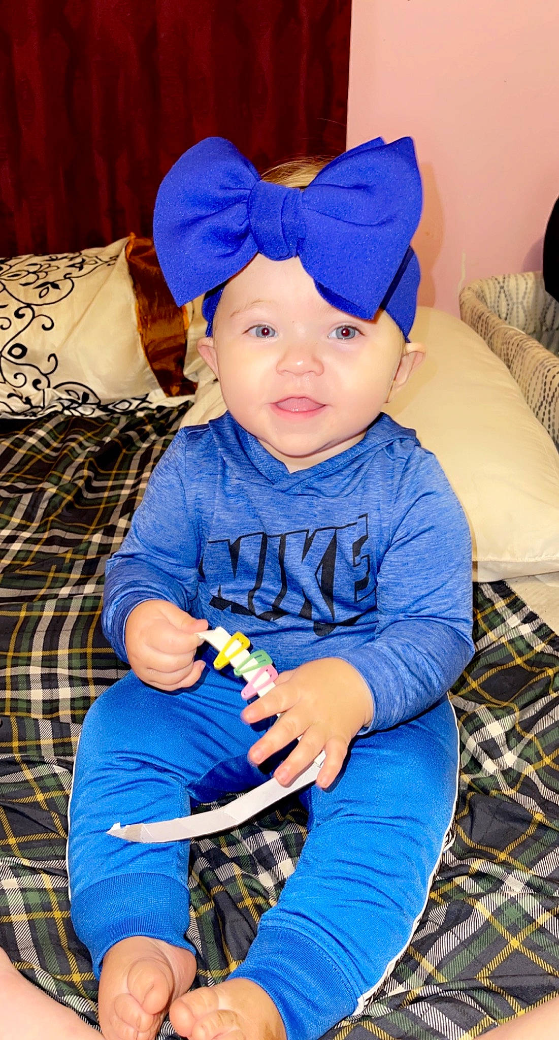 Natalie is registered to the contest to win money with this photo: baby, baby_toddler_clothing, blue, cap, child, costume_hat, electric_blue, fashion_accessory, fun, happy, head, headband, headwear, pattern, person, plaid, purple, sitting, sleeve, t_shirt