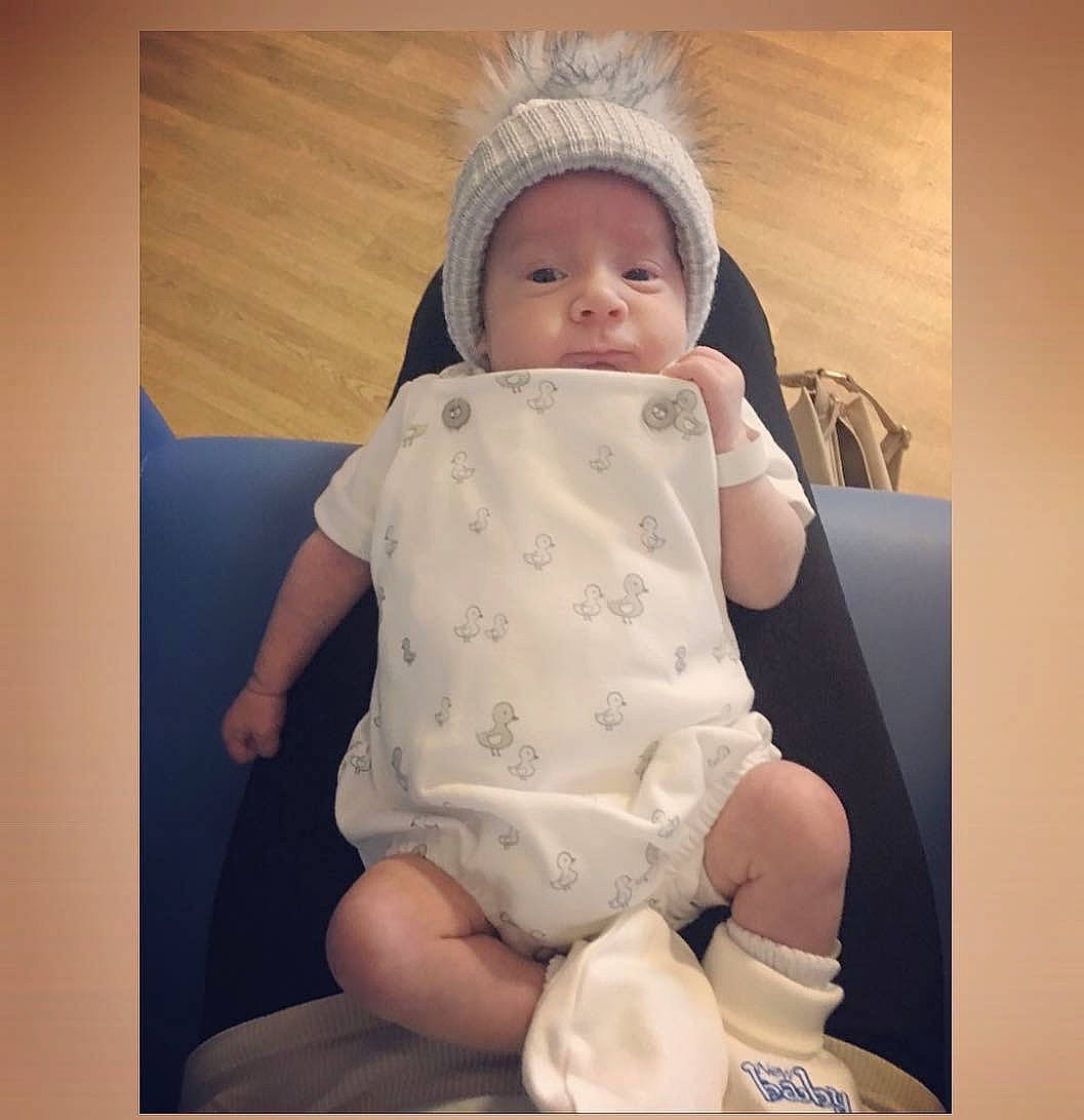 Tyler-jay is registered to the contest to win money with this photo: arm, baby, beige, bonnet, cheek, child, hand, head, headgear, person, product, sitting, skin, toddler