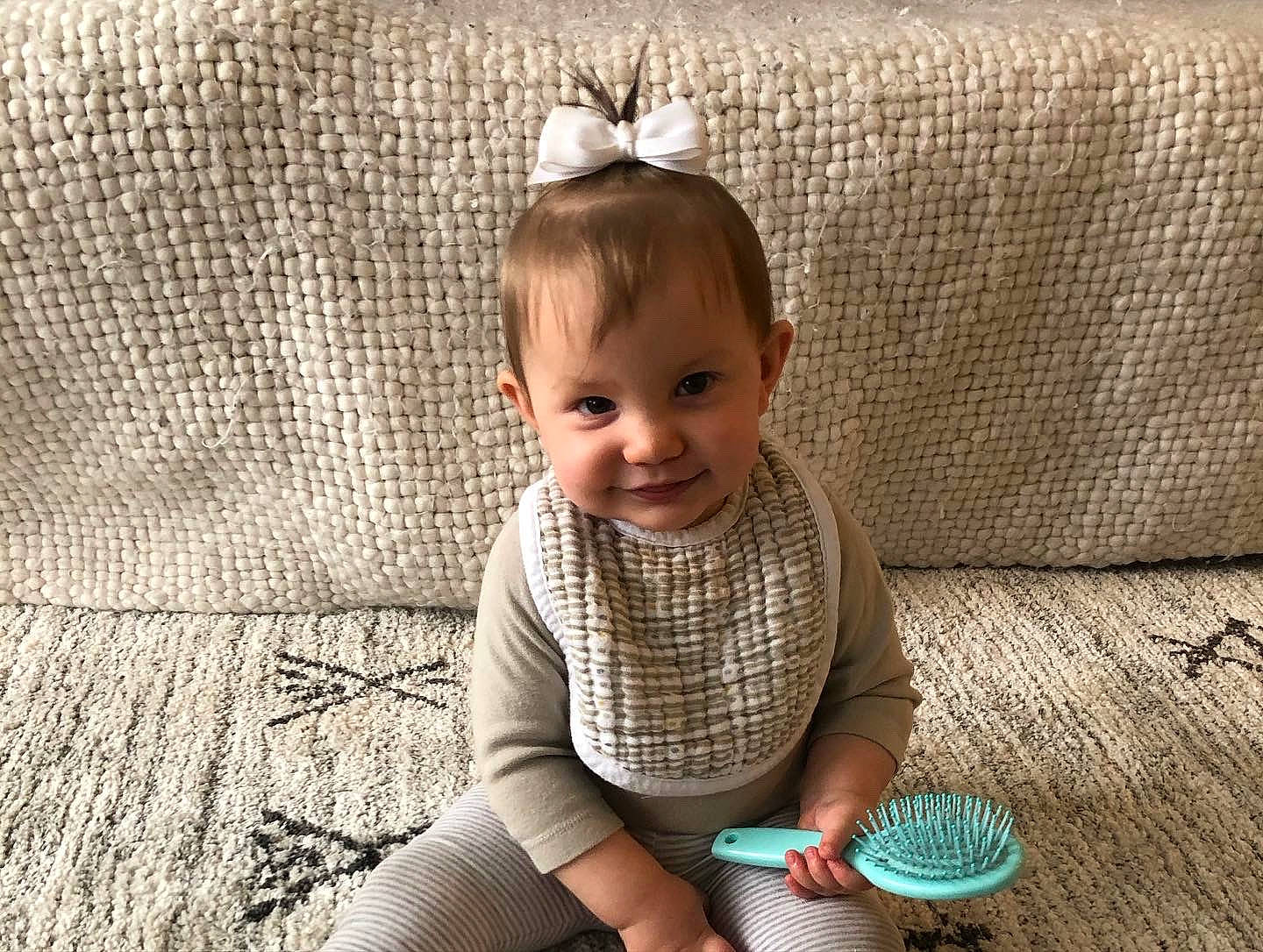 Sayla is registered to the contest to win money with this photo: baby, baby_toddler_clothing, child, comfort, couch, cup, fashion_accessory, flooring, grass, happy, headband, headpiece, joy, pattern, person, sitting, skin, sleeve, smile, tableware