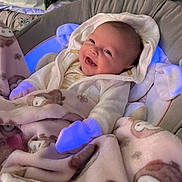 Charlee joined the competition — help win amazing prizes! baby, smiling, blanket, hoodie, infant, cozy, cushion, blue_light, cute, child, portrait, happy, indoors, soft_fabric, seat, warm_clothing, wrapped, newborn, lying_down, comfort