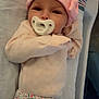 Charlee joined the competition — help win amazing prizes! baby, infant, pacifier, pink_hat, flower_pattern, blanket, sleepwear, soft_lighting, indoor, cute, child, portrait, newborn, resting, clothing, toddler, headwear, face, lying_down, comfort