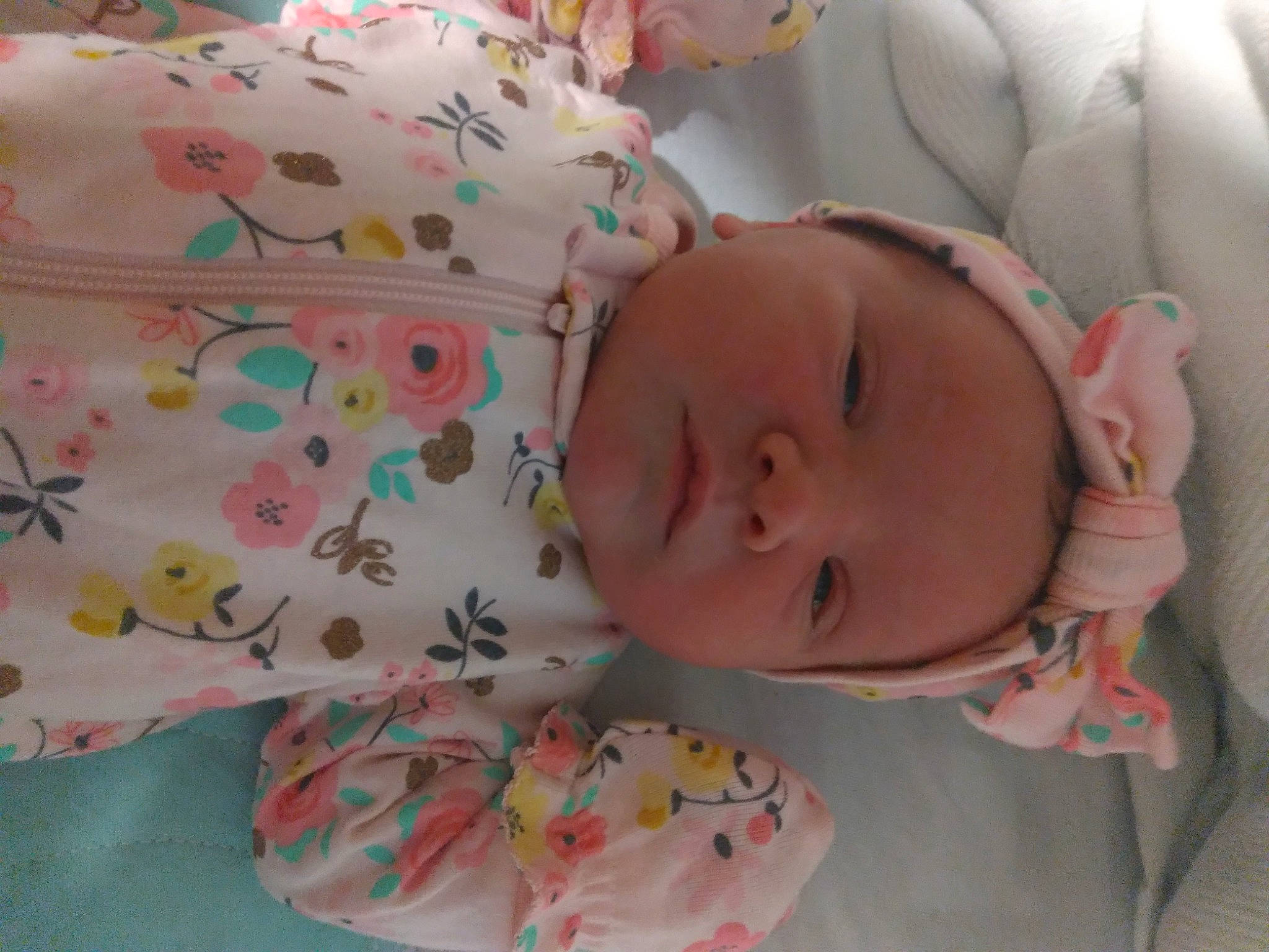 Lilliana is registered to the contest to win money with this photo: arm, baby, baby_toddler_clothing, cheek, comfort, face, hand, head, headgear, human_body, lip, mouth, neck, nose, person, pink, product, skin, sleeve, textile