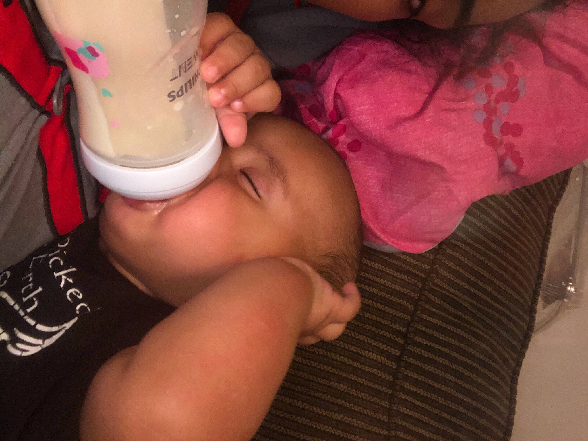 Damian is registered to the contest to win money with this photo: baby, baby_bottle, baby_toddler_clothing, drinking, drinkware, eye, eyelash, finger, fluid, gesture, hand, joint, lip, milk, mouth, nail, neck, person, plastic_bottle, skin