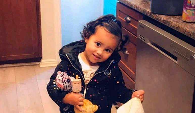 Sandra is registered to the contest to win money with this photo: audio_equipment, cabinetry, chest_of_drawers, child, countertop, cupboard, drawer, flooring, fun, happy, home_appliance, jacket, joy, kitchen, major_appliance, person, room, sitting, skin, sleeve