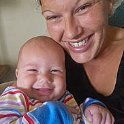 Aires joined the competition — help win amazing prizes! baby, adult, smile, happy, face, person, indoor, closeup, portrait, striped_clothing, colorful, holding, cheerful, candid, skin, head, hand, family, together, joy