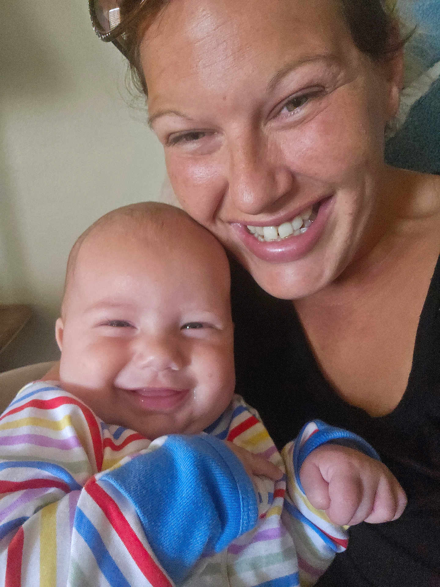 Aires joined the competition — help win amazing prizes! baby, adult, smile, happy, face, person, indoor, closeup, portrait, striped_clothing, colorful, holding, cheerful, candid, skin, head, hand, family, together, joy