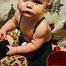 baby, blanket, child, closeup, curious, cute, expression, eyes, face, hand, indoor, infant, leopard_print, person, plush_toy, portrait, red_cup, skin, suspenders, young_child