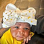 Yasmin a rejoint le concours — aidez-le/la à gagner de superbes lots ! baby, infant, face, headwear, bow, yellow_clothing, hand, skin, portrait, cute, newborn, closeup, expression, resting, indoor, person, child, fashion_accessory, polka_dot, soft_texture