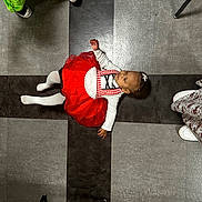 Rayven joined the competition — help win amazing prizes! child, toddler, red_dress, floor, tiles, white_tights, baby, indoor, person, feet, shoes, pattern, crawling, clothing, hair_accessory, flooring, people, legs, playful, young_child