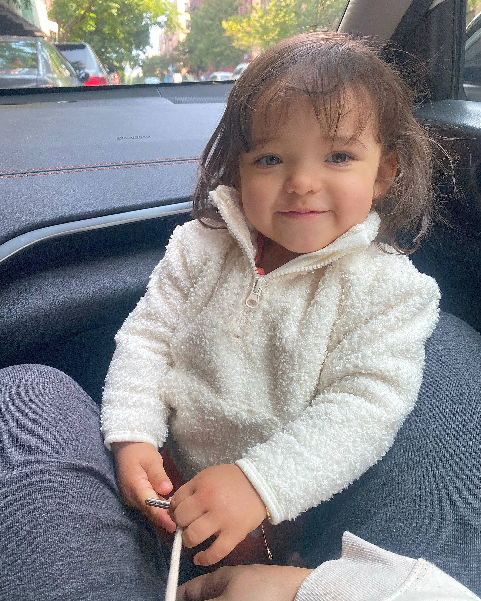 Anayah is registered to the contest to win money with this photo: auto_part, automotive_exterior, baby_toddler_clothing, car, car_seat, child, chin, comfort, family_car, happy, joy, motor_vehicle, person, sitting, skin, sleeve, smile, steering_wheel, thigh, toddler