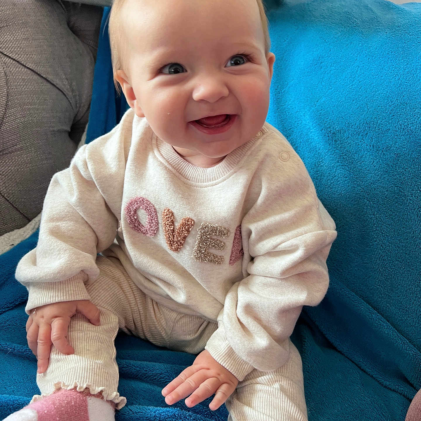 Athena is registered to the contest to win money with this photo: baby, babylaughing, bodypart, clothing, couch, cushion, face, finger, furniture, hand, happy, head, homedecor, laughing, pants, person, photography, portrait, sitting, smile
