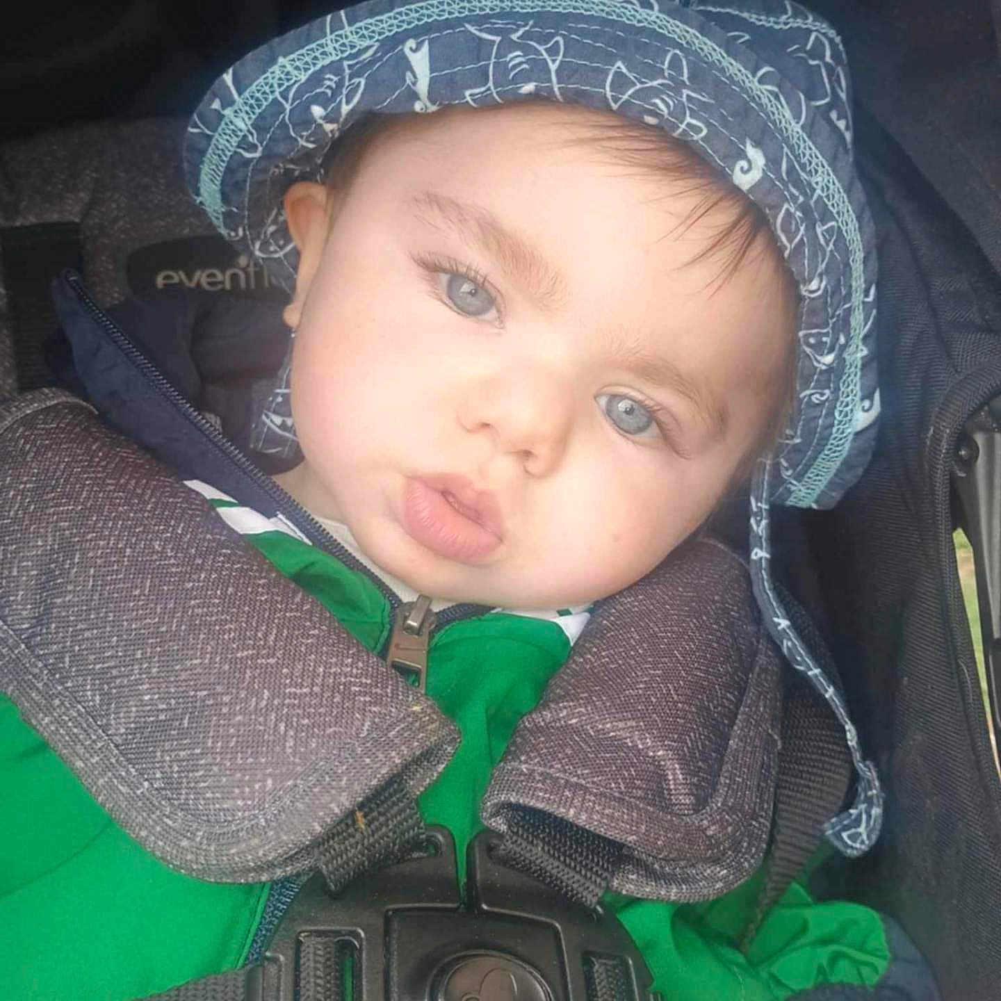 Randy is registered to the contest to win money with this photo: baby, baseballcap, bonnet, cap, clothing, coat, face, gun, hat, head, helmet, hood, jacket, lifejacket, pants, person, photography, portrait, vest, weapon