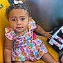 Dream joined the competition — help win amazing prizes! baby, child, girl, curly_hair, bow, floral_dress, gold_shoes, yellow_chair, holding_hands, smiling, portrait, indoor, person, cute, sitting, hand, colorful, happy, fashion, young